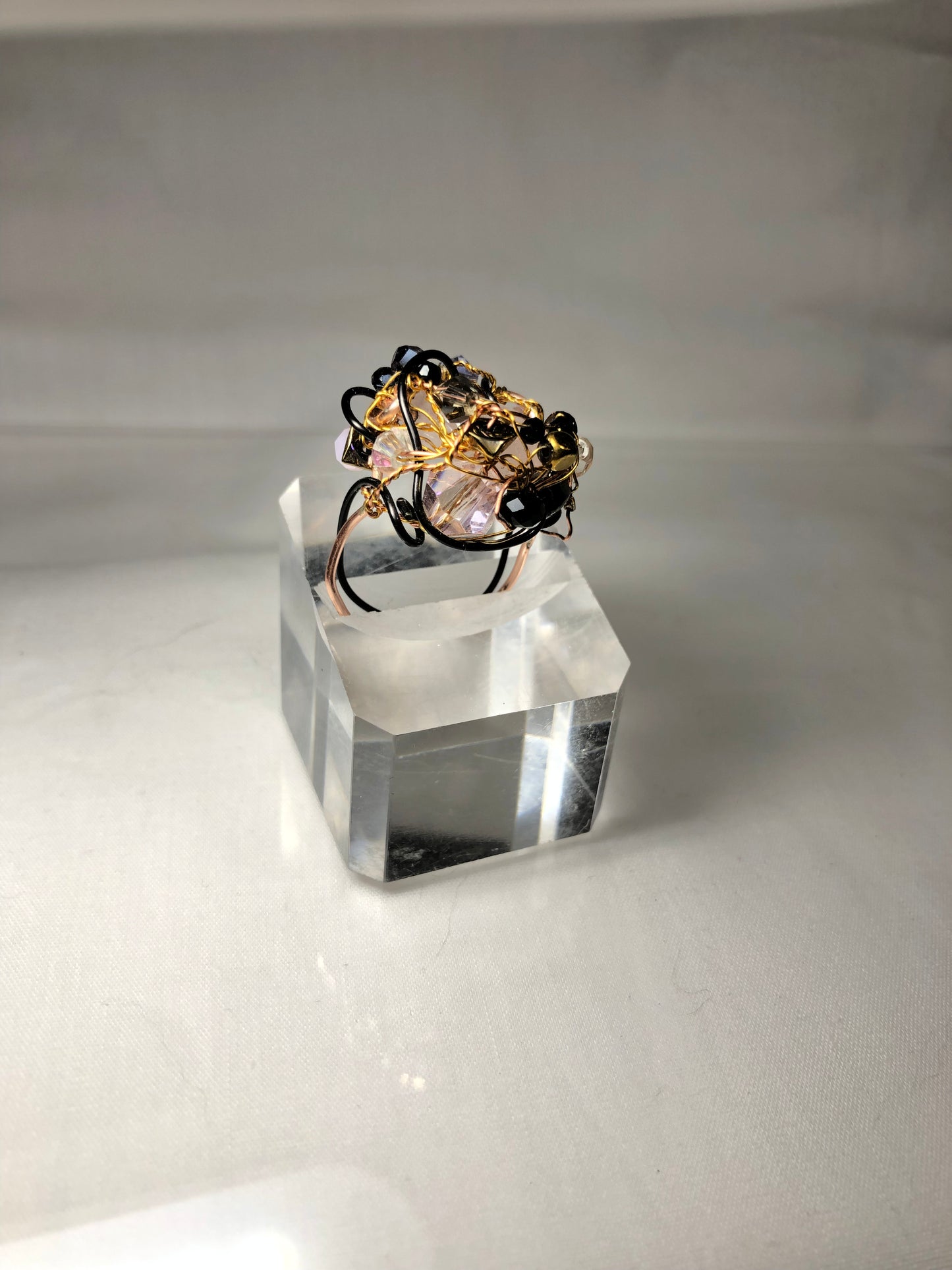 Rose quartz surrounded by dark beads